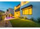 A modern home featuring a pool, artificial turf, and minimalist landscaping at dusk at 4544 N Evans Dr, Scottsdale, AZ 85251