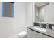 Modern bathroom with sleek vanity, neutral colors, a frameless shower with gray tiling, and bright lighting at 4544 N Evans Dr, Scottsdale, AZ 85251