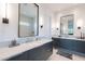 Modern bathroom with double vanity, stone countertop, and framed mirrors at 4544 N Evans Dr, Scottsdale, AZ 85251