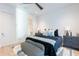 Bright bedroom with dark blue accents, plush bedding, stylish rug, and plenty of natural light at 4544 N Evans Dr, Scottsdale, AZ 85251