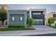 Modern home showcasing a sleek design with a glass garage door and manicured landscaping at 4544 N Evans Dr, Scottsdale, AZ 85251