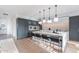 Sleek kitchen featuring a waterfall island with bar seating and pendant lighting at 4544 N Evans Dr, Scottsdale, AZ 85251