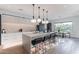 Contemporary kitchen with island seating, pendant lights, and open access to the dining area at 4544 N Evans Dr, Scottsdale, AZ 85251