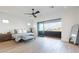 Bright bedroom features a ceiling fan, a balcony and light hardwood floors at 4544 N Evans Dr, Scottsdale, AZ 85251