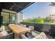 Inviting outdoor patio features a dining set with views of the golf course and lush landscaping at 4544 N Evans Dr, Scottsdale, AZ 85251