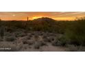 Tranquil desert sunset casts a warm glow over the Arizona landscape with mountains in the background at 8922 E Covey Trl, Scottsdale, AZ 85262