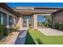 Modern home exterior with stone accents and a welcoming entryway at 8366 E Old Paint Trl, Scottsdale, AZ 85266