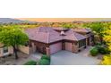 Aerial shot showcasing the home's tile roof, desert landscaping, and three car garage at 12797 S 179Th Dr, Goodyear, AZ 85338