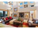 Spacious living room with a stone fireplace and high ceilings at 14021 E Milton Ct, Scottsdale, AZ 85262