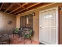 Inviting condo entryway with patio furniture and a security door at 14203 N 19Th Ave # 1055, Phoenix, AZ 85023