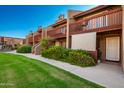 Condo building exterior showcasing multiple units and a well-maintained lawn at 14203 N 19Th Ave # 1055, Phoenix, AZ 85023