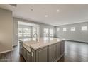 Bright, open-concept kitchen featuring a large island with a farmhouse sink and stainless steel appliances at 578 E Las Puertas Ln, Queen Creek, AZ 85140