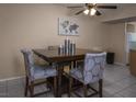 The dining area includes a wood table with four upholstered chairs and a decorative ceiling fan at 2228 N 52Nd St # 227, Phoenix, AZ 85008