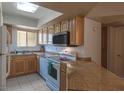 This functional kitchen offers sleek countertops, stainless appliances, and bright natural lighting at 2228 N 52Nd St # 227, Phoenix, AZ 85008