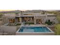 Inviting backyard features a sparkling pool, lounge chairs, and outdoor dining with scenic mountain views at 36421 N 105Th Pl, Scottsdale, AZ 85262