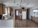 Bright kitchen featuring wood cabinets, light counters, wood floors, and modern appliances at 8103 E Southern Ave # 24, Mesa, AZ 85209