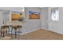 Entryway with kitchen view, tile floors and two brown stools at 17156 W Lachlan Ct, Surprise, AZ 85387