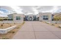 A modern desert home with a long driveway and manicured landscape at 12297 E Troon Vista Dr # 255, Scottsdale, AZ 85255