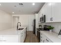 Well-lit kitchen with stainless steel appliances, matte black fixtures, and quartz countertops at 18450 E Camila Dr, Gold Canyon, AZ 85118