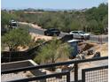 Scenic neighborhood view featuring lush desert vegetation, other houses, and distant mountains in the background at 37445 N 104Th Pl, Scottsdale, AZ 85262