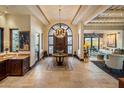 Elegant entryway with a beautiful chandelier and ornate front door at 26761 N 98Th Way, Scottsdale, AZ 85262