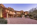 Stunning estate home exterior with a large driveway and mountain backdrop at 26761 N 98Th Way, Scottsdale, AZ 85262