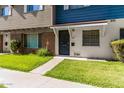 Attractive townhome exhibiting a beautiful front lawn that guides you to the striking black front door at 1673 W Hazelwood St, Phoenix, AZ 85015