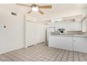 Bright kitchen with white appliances, cabinets and tiled floor, ready for culinary adventures at 1673 W Hazelwood St, Phoenix, AZ 85015