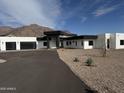 Stunning modern home featuring a black and white design, desert landscaping, and a mountain view at 3525 S Kings Ranch Ct # 4, Gold Canyon, AZ 85118
