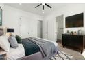 Contemporary main bedroom with neutral tones, ceiling fan, and access to ensuite bathroom and closet at 31712 N 169Th Ave, Surprise, AZ 85387