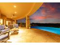Covered patio with comfortable seating overlooking the pool and city lights at 9025 N Flying Butte --, Fountain Hills, AZ 85268