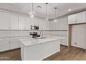 Spacious kitchen with white cabinets, stainless steel appliances, and a large center island at 18795 E Elizar Dr, Gold Canyon, AZ 85118