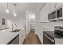 Well-designed kitchen with stainless steel appliances, white cabinets, and an open layout at 18795 E Elizar Dr, Gold Canyon, AZ 85118