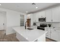 Modern kitchen featuring white cabinets, a central island with a sink, and stainless steel appliances at 18507 E Camila Dr, Gold Canyon, AZ 85118