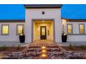 Inviting home entrance featuring a brick pathway, decorative planters and glass paneled door at 17448 W Carlisle Dr, Surprise, AZ 85388