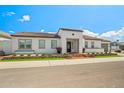 Charming single-story home with a modern exterior design, a tile roof, brick accents, and a well-maintained front yard at 17448 W Carlisle Dr, Surprise, AZ 85388