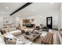 Open-concept living room with modern furnishings, hardwood floors, and natural light, creating a welcoming space at 17448 W Carlisle Dr, Surprise, AZ 85388