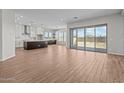 Spacious living area boasts wood-style floors, abundant natural light, and seamless access to the outdoor space at 4315 S 123Rd Ave, Avondale, AZ 85323