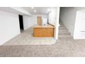 Finished basement features tile and carpet flooring, wooden bar, and staircase at 15303 E Rio Verde Dr, Scottsdale, AZ 85262