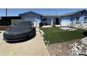 Charming blue single-story home featuring newly installed artificial grass and rock details at 5007 W Weldon Ave, Phoenix, AZ 85031