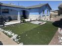 Charming blue single-story home featuring newly installed artificial grass and rock details at 5007 W Weldon Ave, Phoenix, AZ 85031