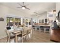 Bright dining area with large windows offering a view of the pool, complemented by stylish furnishings and modern lighting at 1660 N 59Th St, Mesa, AZ 85205