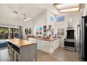 Well-lit kitchen with a butcher block island, modern appliances, and ample storage, perfect for cooking and entertaining at 1660 N 59Th St, Mesa, AZ 85205