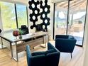 Bright office space with a modern desk, stylish seating, and expansive views of desert landscape at 24724 N 119Th Pl, Scottsdale, AZ 85255