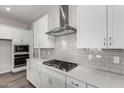 Modern kitchen boasts white cabinets, stainless steel appliances, and quartz countertops at 16400 W Avenida Del Sol --, Surprise, AZ 85387