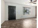 Living room with tile flooring, dark brown front door, and ceiling fan at 7950 E Keats Ave # 133, Mesa, AZ 85209