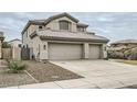 Charming two-story home featuring a three-car garage and desert landscaping at 4803 E Barwick Dr, Cave Creek, AZ 85331
