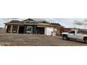 Exterior view of a house under construction, showing incomplete walls, and a pickup truck in front at 1716 W Caramel Ct, Queen Creek, AZ 85144