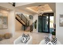 Grand entryway with modern staircase and chandelier at 29646 N 109Th Pl # 128, Scottsdale, AZ 85262