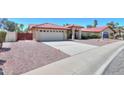 Lovely home with a red tile roof, two-car garage, and low-maintenance desert landscaping at 2119 N Lake Shore Dr, Casa Grande, AZ 85122